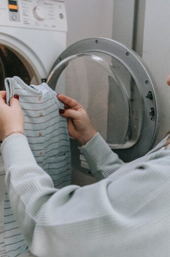 mujer realizando lavado de ropa en lavadora