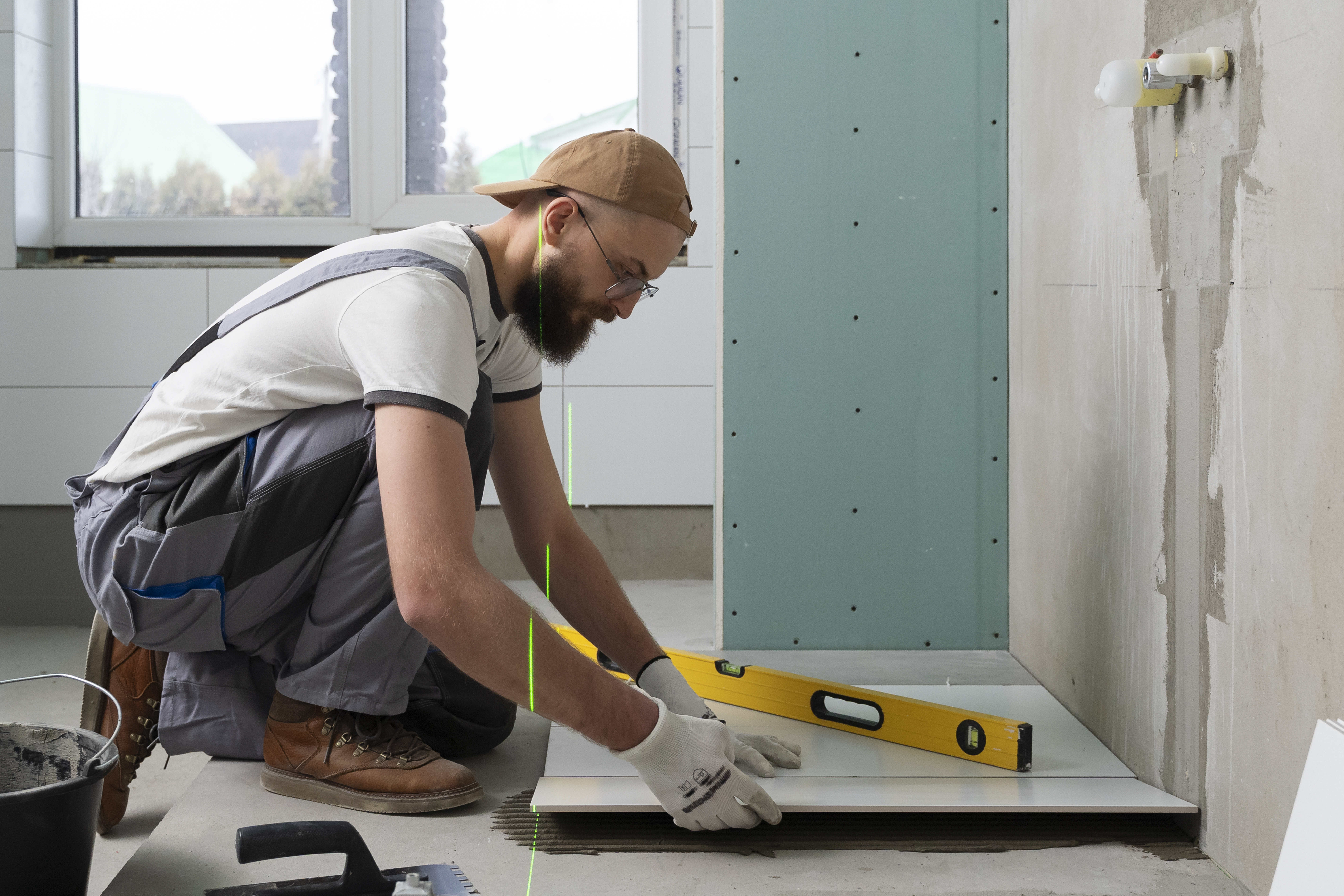 Especialista realizando trabajos de remodelación de baños en un espacio moderno con enchapes, sanitarios y acabados renovados