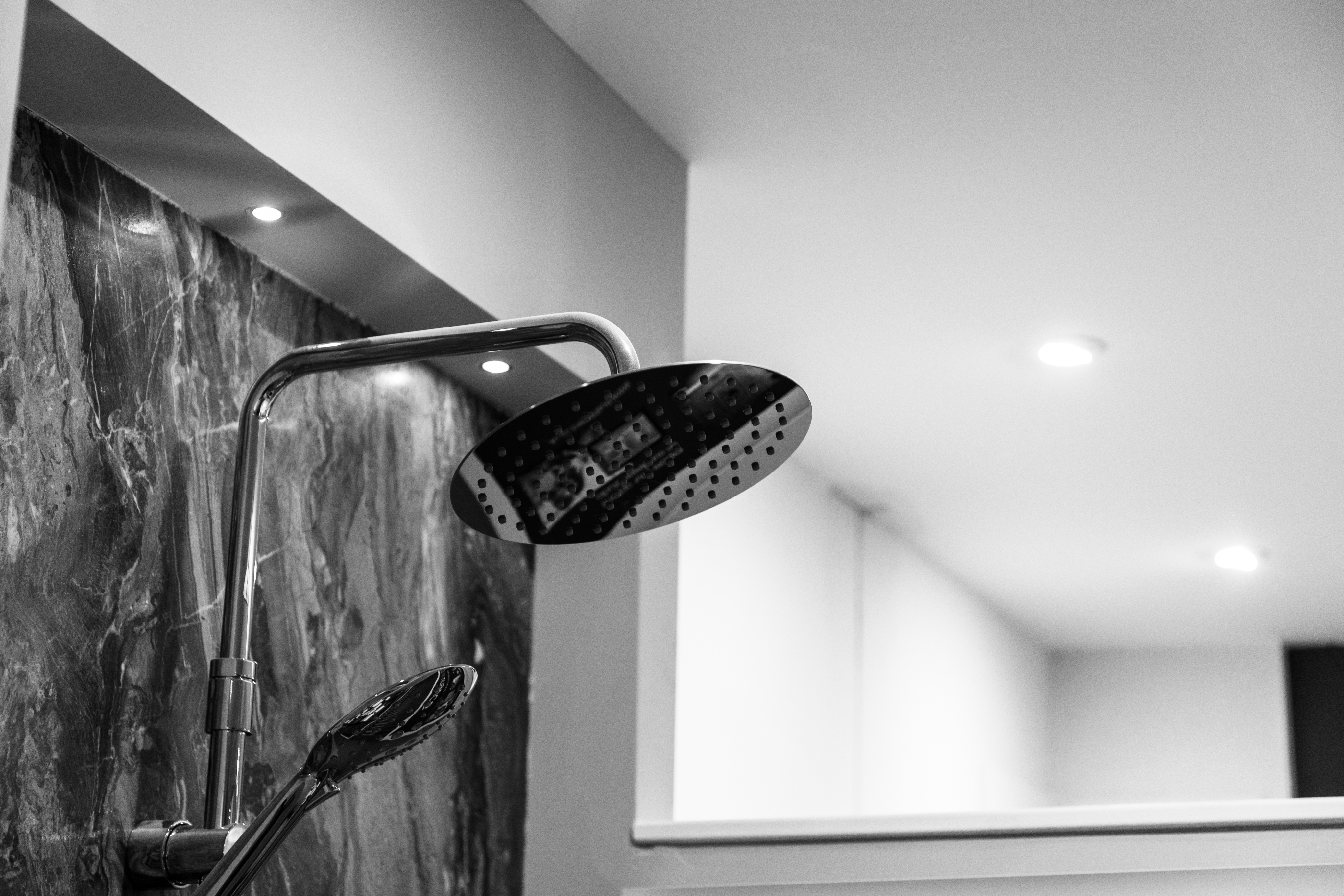 Resultado de instalación de ducha por un técnico con cabezal grande en baño de lujo 